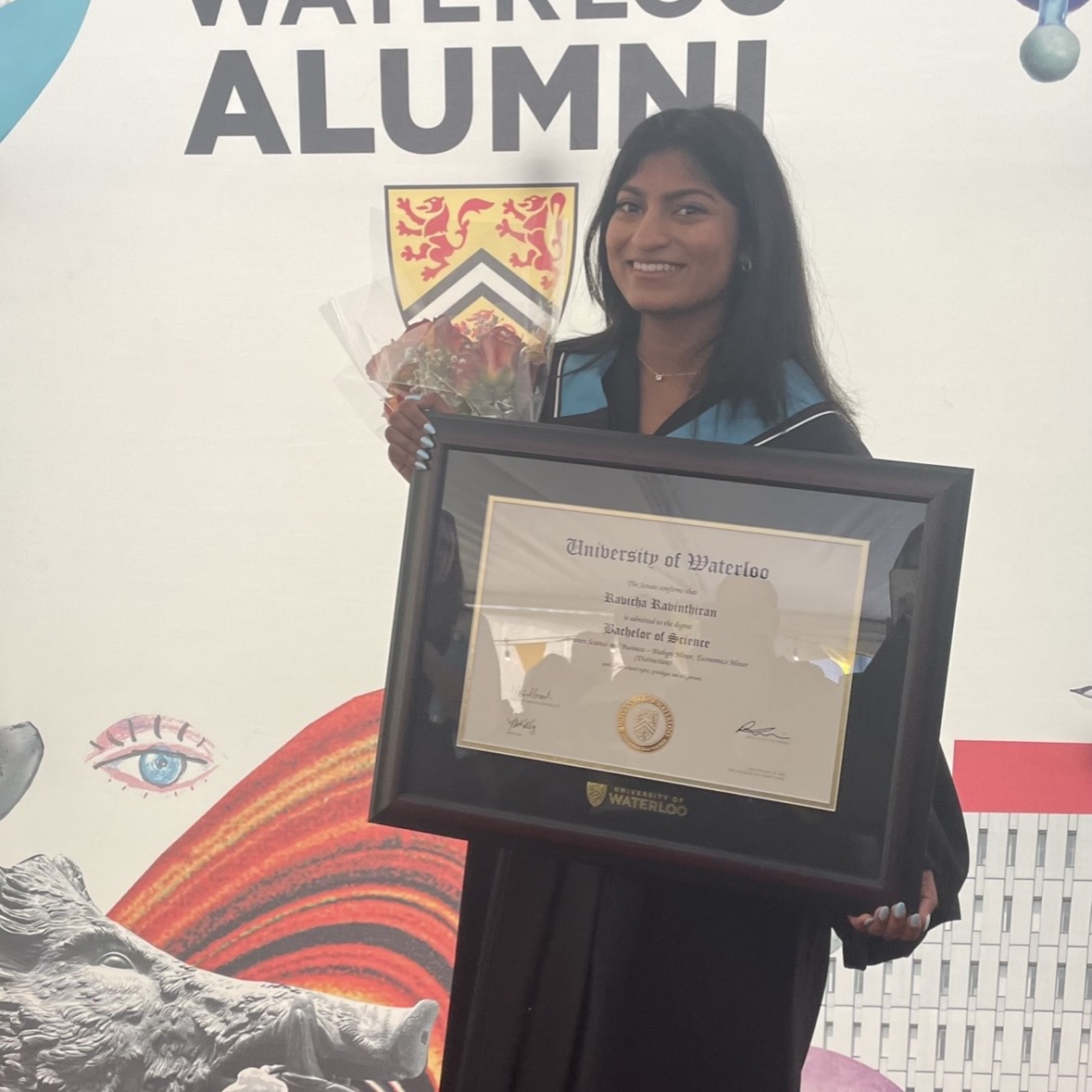 Ravicha holding her University of Waterloo diploma